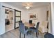 Bright dining room with barn door leading to kitchen, contemporary art, and seating for six at 920 Spruce Dr, Belleair Beach, FL 33786