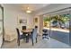 Cozy dining room with sliding glass doors to outdoor deck, ceiling fan and barn door at 920 Spruce Dr, Belleair Beach, FL 33786