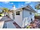 Exterior showcasing the back of the home, a wooden deck, and lush tropical landscaping at 920 Spruce Dr, Belleair Beach, FL 33786