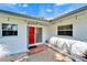 Inviting entrance with a striking red door, patterned tile, and well-lit porch at 920 Spruce Dr, Belleair Beach, FL 33786