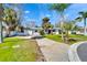 Single-story home with a long driveway and lush green lawn at 920 Spruce Dr, Belleair Beach, FL 33786