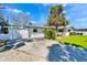 Single-story home with a concrete driveway and lush green lawn at 920 Spruce Dr, Belleair Beach, FL 33786