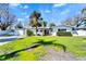 Charming single-story home with well-manicured lawn and vibrant tropical landscaping at 920 Spruce Dr, Belleair Beach, FL 33786