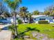 Charming single Gathering home featuring a two car garage and tropical landscaping at 920 Spruce Dr, Belleair Beach, FL 33786