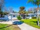 Charming single Gathering home featuring a two car garage and tropical landscaping at 920 Spruce Dr, Belleair Beach, FL 33786