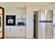 Modern kitchen featuring stainless steel appliances, white cabinets, and a built-in oven at 920 Spruce Dr, Belleair Beach, FL 33786