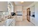 Kitchen with white cabinets, granite countertops, stainless steel appliances, and natural light at 920 Spruce Dr, Belleair Beach, FL 33786