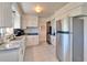 Kitchen featuring white cabinets, granite countertops, and stainless steel appliances at 920 Spruce Dr, Belleair Beach, FL 33786