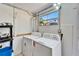 Laundry area with a stacked washer and dryer, and a window for natural light at 920 Spruce Dr, Belleair Beach, FL 33786