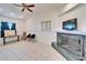 Sunlit living room with tile flooring, a decorative fireplace, and ample space at 920 Spruce Dr, Belleair Beach, FL 33786