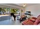 Bright living space with sliding glass doors to the outdoor deck, a leather sofa, and modern decor at 920 Spruce Dr, Belleair Beach, FL 33786