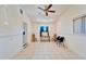 Bright and airy living room with tile flooring, ample lighting, and convenient room access at 920 Spruce Dr, Belleair Beach, FL 33786