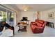 Comfortable living area with sliding glass doors to the backyard, a leather sofa, and neutral decor at 920 Spruce Dr, Belleair Beach, FL 33786