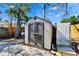 Outdoor storage shed with double doors and a paved base at 920 Spruce Dr, Belleair Beach, FL 33786