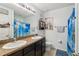 Bathroom with double sinks, blue accents, and a tiled floor, showcasing a clean design at 9756 Hound Chase Dr, Gibsonton, FL 33534