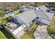 Aerial view of the home, backyard, patio, and a Mako boat on a trailer, all enclosed by a white fence at 1015 Coldstream Ct, Tarpon Springs, FL 34689