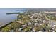 Scenic aerial view of neighborhood near the water featuring lush landscaping, beautiful homes, and water views at 1015 Coldstream Ct, Tarpon Springs, FL 34689