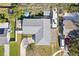 Aerial view of home with new roof and lush backyard featuring patio and boat on trailer at 1015 Coldstream Ct, Tarpon Springs, FL 34689