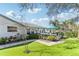 A lush backyard featuring artificial turf, a patio and tropical landscaping at 1015 Coldstream Ct, Tarpon Springs, FL 34689
