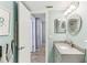 Stylish bathroom featuring granite countertop, mosaic mirror and fresh, light blue walls at 1015 Coldstream Ct, Tarpon Springs, FL 34689