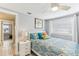 Inviting bedroom features colorful bedding, window, and access to another room at 1015 Coldstream Ct, Tarpon Springs, FL 34689