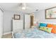 Charming bedroom features colorful bedding, dresser, and access to another room at 1015 Coldstream Ct, Tarpon Springs, FL 34689