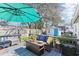 A relaxing backyard deck area with comfortable outdoor seating and an umbrella for shade at 1015 Coldstream Ct, Tarpon Springs, FL 34689
