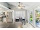 Bright dining area features a modern ceiling fan, white shutters and a view of the landscaped backyard at 1015 Coldstream Ct, Tarpon Springs, FL 34689