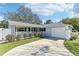 Charming single-story home featuring a well-manicured lawn, classic shutters, and attached two-car garage at 1015 Coldstream Ct, Tarpon Springs, FL 34689