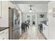 Kitchen with stainless steel refrigerator, adjacent to dining area with backyard patio access at 1015 Coldstream Ct, Tarpon Springs, FL 34689
