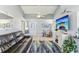 Inviting living room with neutral paint, ceiling fan, comfortable seating, wood-look floors, and natural light at 1015 Coldstream Ct, Tarpon Springs, FL 34689