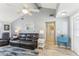 Comfortable living room with neutral paint, wood-look floors, plenty of seating, and bright natural light at 1015 Coldstream Ct, Tarpon Springs, FL 34689