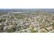 Aerial neighborhood shot featuring the home and surrounding community with trees and small lakes at 1015 Coldstream Ct, Tarpon Springs, FL 34689