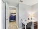 Home office area with a white desk, printer, and a view into another room at 1015 Coldstream Ct, Tarpon Springs, FL 34689