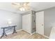 Room featuring a closet, coat rack, desk, ceiling fan, and neutral color palette at 1015 Coldstream Ct, Tarpon Springs, FL 34689
