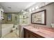 Bathroom features a walk-in shower, soaking tub, granite countertop and updated fixtures at 12030 Steppingstone Blvd, Tampa, FL 33635