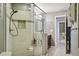 Shower features a glass enclosure, tiled walls, and updated fixtures at 12030 Steppingstone Blvd, Tampa, FL 33635