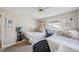 Bedroom featuring two beds, a ceiling fan, and a window for natural light at 12030 Steppingstone Blvd, Tampa, FL 33635