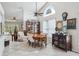 Inviting dining room with high ceilings, a decorative window, a wooden table with seating for six, and stylish décor at 12030 Steppingstone Blvd, Tampa, FL 33635