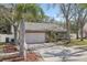 Charming single-story home featuring a stone facade, two-car garage, and a well-manicured front yard at 12030 Steppingstone Blvd, Tampa, FL 33635