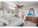 Bright main bedroom features a ceiling fan, tiled floors and an ensuite bathroom at 12030 Steppingstone Blvd, Tampa, FL 33635
