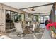 Enclosed patio features a ceiling fan, outdoor seating, and view to backyard at 12030 Steppingstone Blvd, Tampa, FL 33635