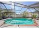 Refreshing screened-in pool featuring a brick border for enhanced style at 12030 Steppingstone Blvd, Tampa, FL 33635