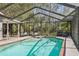 Inviting screened-in pool area with lounge chairs, perfect for relaxation and enjoying the outdoors at 12030 Steppingstone Blvd, Tampa, FL 33635
