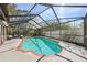 Inviting screened-in pool with a brick-lined border and lots of deck space at 12030 Steppingstone Blvd, Tampa, FL 33635