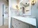 Bathroom featuring a bright vanity with marble countertop and a large mirror above the sink at 1309 Hillside Dr, Tarpon Springs, FL 34689