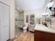 Bathroom featuring a glass shower, storage cabinet, vanity, and decorative lighting at 1309 Hillside Dr, Tarpon Springs, FL 34689