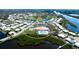 Aerial view of community center, pool, shuffleboard and surrounding neighborhood by a scenic waterway at 1320 Bottlebrush Dr, Bradenton, FL 34208
