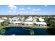 Aerial photograph exhibits a cozy home within a charming residential community near a pond at 1320 Bottlebrush Dr, Bradenton, FL 34208