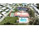 Aerial view of community center with pool, shuffleboard courts, and parking in a vibrant neighborhood at 1320 Bottlebrush Dr, Bradenton, FL 34208